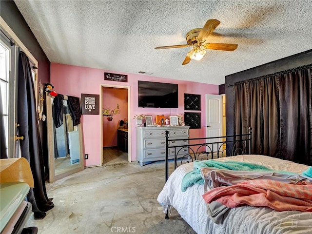 20715 Teton Rd, Apple Valley, CA 92308 - bedroom featuring a textured ceiling, unfinished concrete flooring, and a ceiling fan