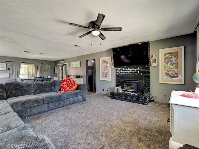 20715 Teton Rd, Apple Valley, CA 92308 - living area with carpet flooring, ceiling fan, a wood stove, and a textured ceiling