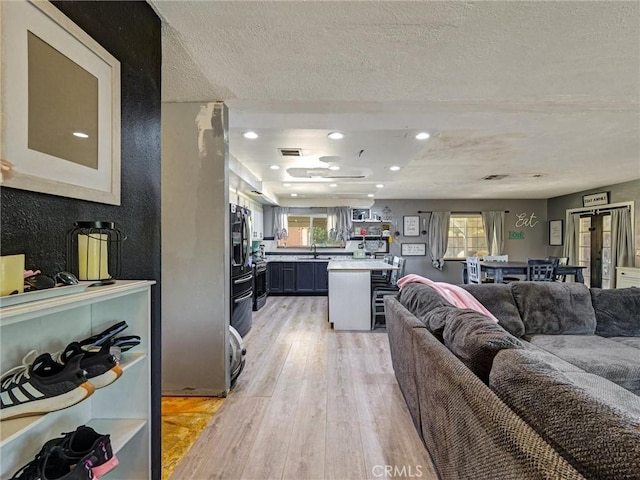 20715 Teton Rd, Apple Valley, CA 92308 - living room with light wood finished floors, a textured ceiling, and recessed lighting