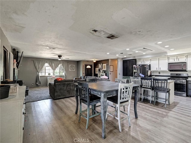 20715 Teton Rd, Apple Valley, CA 92308 - dining space featuring a textured ceiling, light wood-type flooring, a ceiling fan, and recessed lighting