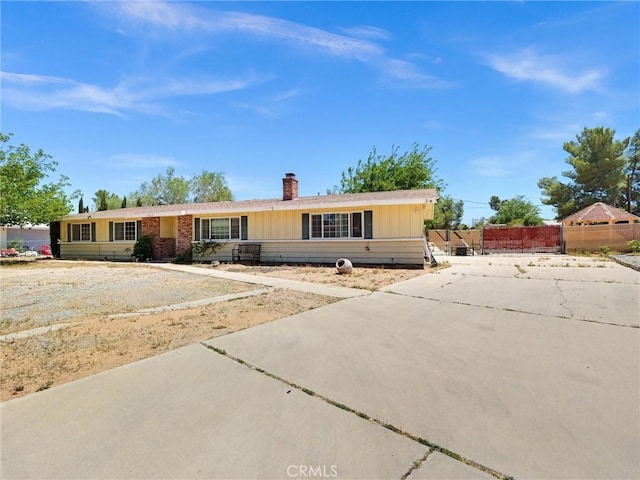 20715 Teton Rd, Apple Valley, CA 92308 - single story home featuring concrete driveway and a chimney