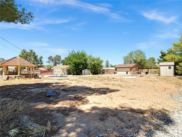 20715 Teton Rd, Apple Valley, CA 92308 - view of yard featuring a storage shed and a gazebo