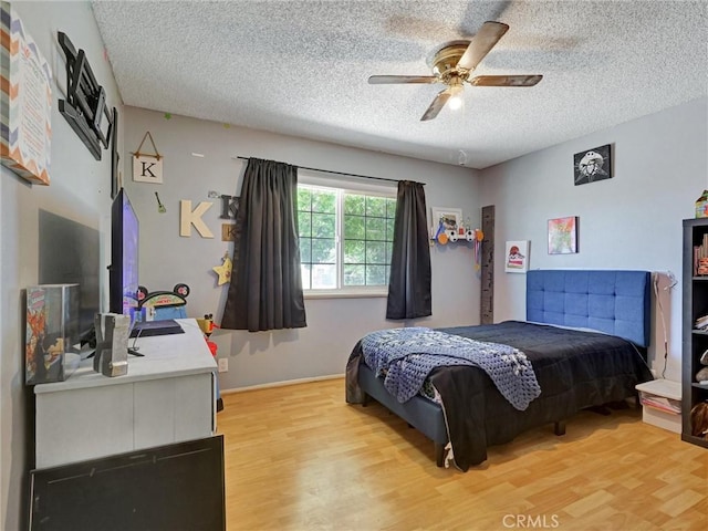 20715 Teton Rd, Apple Valley, CA 92308 - bedroom with a textured ceiling, light wood-type flooring, and a ceiling fan