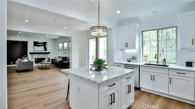 53 Via Armilla, San Clemente, CA 92673 - kitchen featuring dishwasher, light wood-type flooring, a kitchen island, white cabinetry, and decorative backsplash