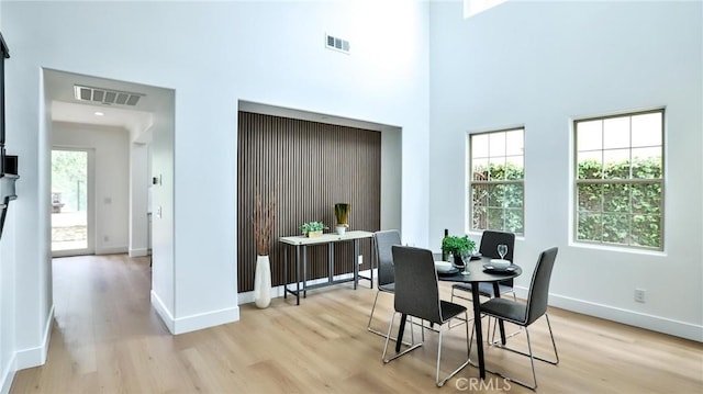 53 Via Armilla, San Clemente, CA 92673 - dining area with light wood-type flooring, baseboards, healthy amount of natural light, and a towering ceiling
