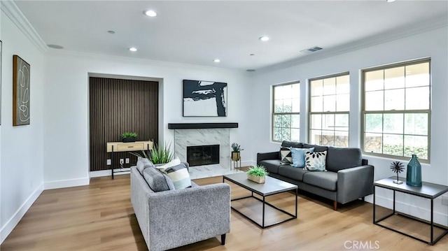 53 Via Armilla, San Clemente, CA 92673 - living area featuring healthy amount of natural light, light wood-style flooring, crown molding, a fireplace, and recessed lighting