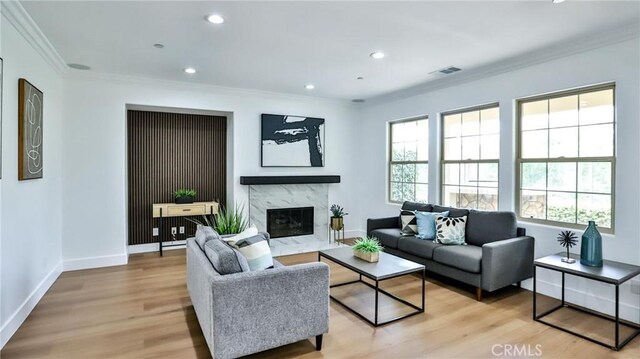 53 Via Armilla, San Clemente, CA 92673 - living room featuring healthy amount of natural light, light wood finished floors, ornamental molding, a high end fireplace, and recessed lighting