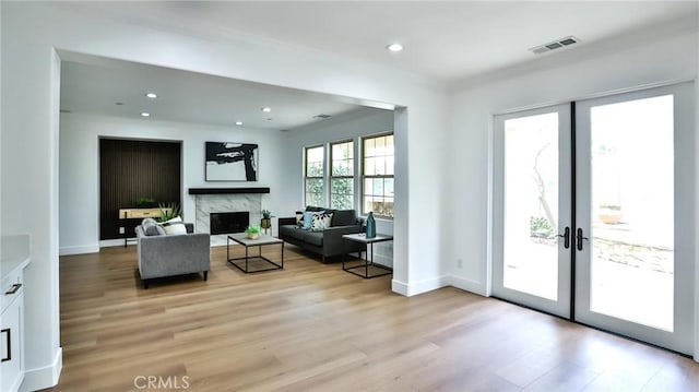 53 Via Armilla, San Clemente, CA 92673 - living area with a high end fireplace, light wood-style floors, ornamental molding, recessed lighting, and french doors