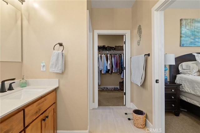 1622 Paradisewood Dr, Paradise, CA 95969 - bathroom featuring vanity, ensuite bath, a walk in closet, and baseboards