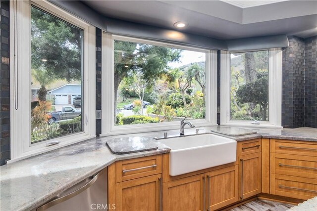 29515 Weeping Willow Dr, Agoura Hills, CA 91301 - kitchen with a sink, stainless steel dishwasher, light stone countertops, brown cabinetry, and crown molding