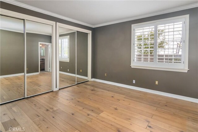 29515 Weeping Willow Dr, Agoura Hills, CA 91301 - unfurnished bedroom with multiple closets, ornamental molding, hardwood / wood-style flooring, and baseboards