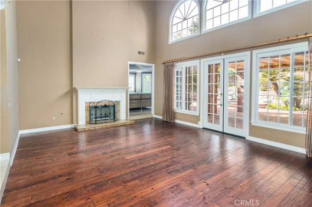29515 Weeping Willow Dr, Agoura Hills, CA 91301 - unfurnished living room featuring wood-type flooring, baseboards, a high ceiling, french doors, and a fireplace with raised hearth