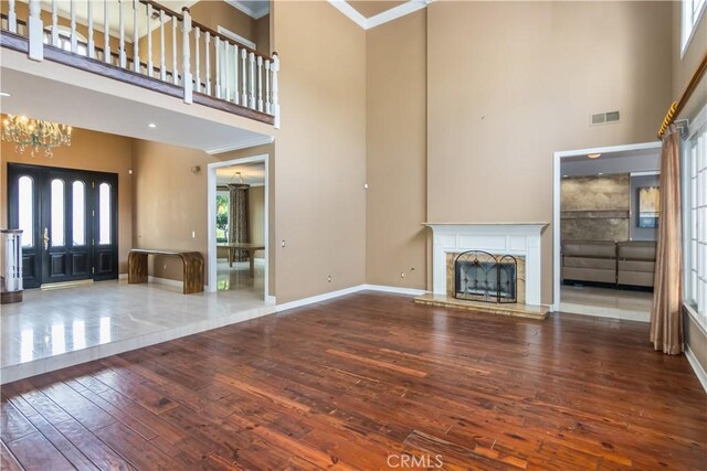 29515 Weeping Willow Dr, Agoura Hills, CA 91301 - unfurnished living room with a towering ceiling, wood-type flooring, ornamental molding, baseboards, and a fireplace with raised hearth