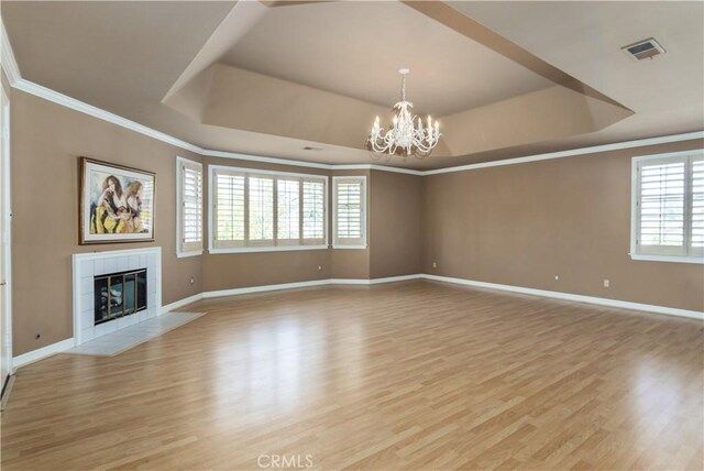 29515 Weeping Willow Dr, Agoura Hills, CA 91301 - unfurnished living room featuring a raised ceiling, a chandelier, crown molding, light wood-type flooring, and baseboards