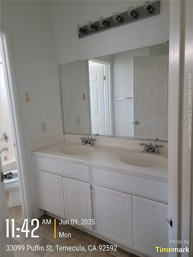 33099 Puffin St, Temecula, CA 92592 - bathroom featuring double vanity, tile patterned floors, and a tub