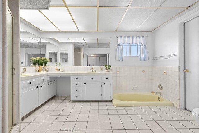143581/2 Jeanette Ln, Baldwin Park, CA 91706 - bathroom featuring a garden tub, vanity, tile patterned flooring, and toilet