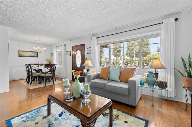 143581/2 Jeanette Ln, Baldwin Park, CA 91706 - living area with a textured ceiling, a chandelier, and wood finished floors