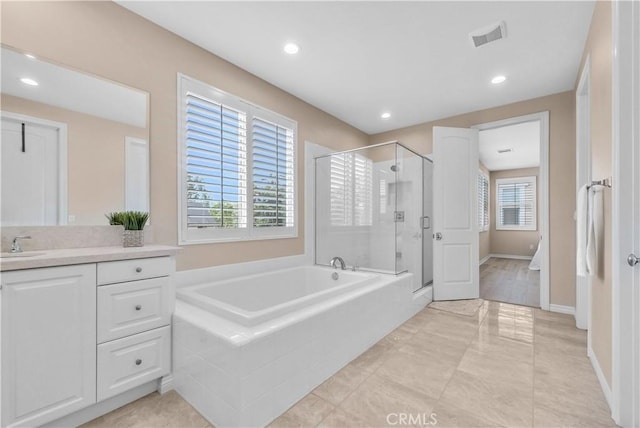 9936 Pear Dr, Westminster, CA 92683 - bathroom featuring vanity, a bath, a shower stall, recessed lighting, and baseboards