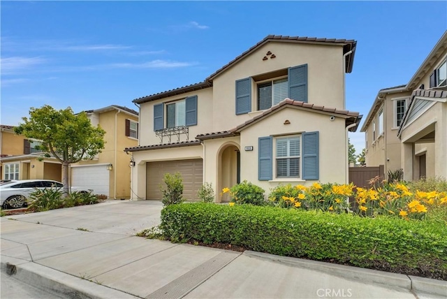 9936 Pear Dr, Westminster, CA 92683 - mediterranean / spanish house with stucco siding, a garage, a tile roof, and concrete driveway