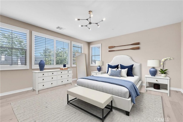 9936 Pear Dr, Westminster, CA 92683 - bedroom featuring light wood-type flooring, a chandelier, and baseboards