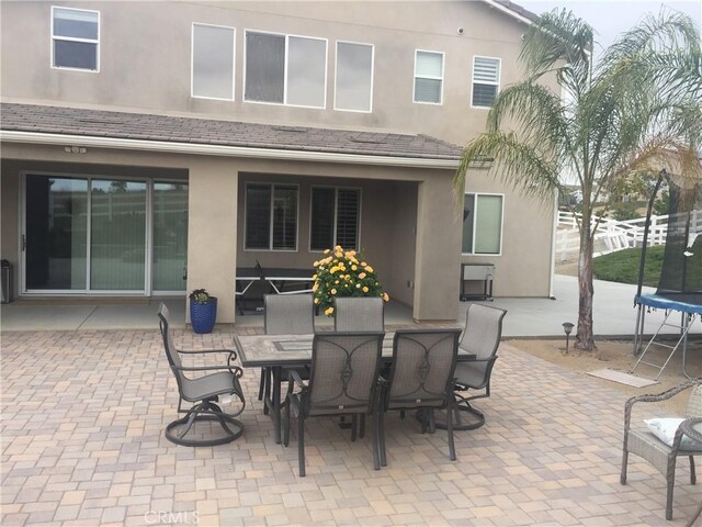 17426 Fairbreeze Ct, Riverside, CA 92504 - view of patio featuring a trampoline and outdoor dining area