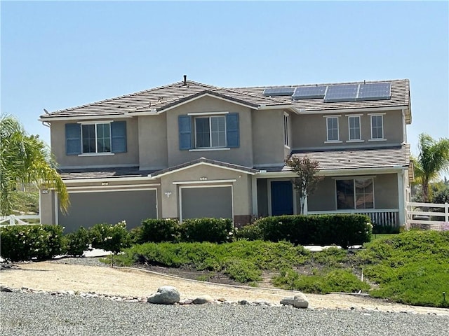 17426 Fairbreeze Ct, Riverside, CA 92504 - traditional-style home featuring a garage, stucco siding, a tile roof, and roof mounted solar panels