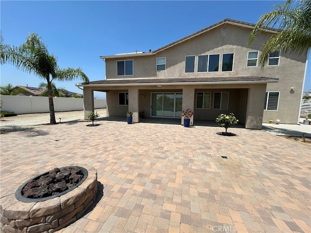 17426 Fairbreeze Ct, Riverside, CA 92504 - rear view of house with a patio area, stucco siding, and an outdoor fire pit