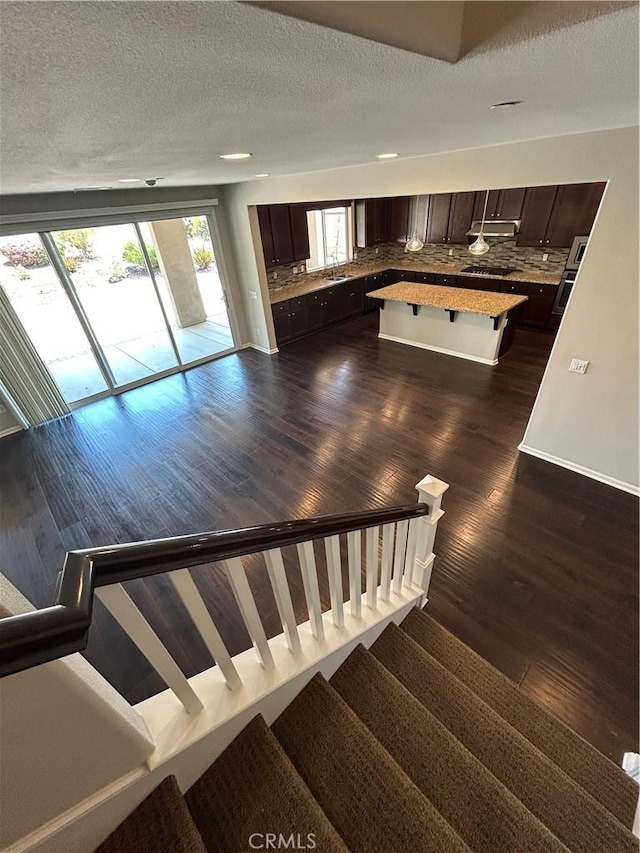17426 Fairbreeze Ct, Riverside, CA 92504 - stairs with wood finished floors and a textured ceiling
