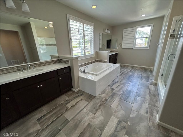 17426 Fairbreeze Ct, Riverside, CA 92504 - full bath with a stall shower, two vanities, a bath, and recessed lighting