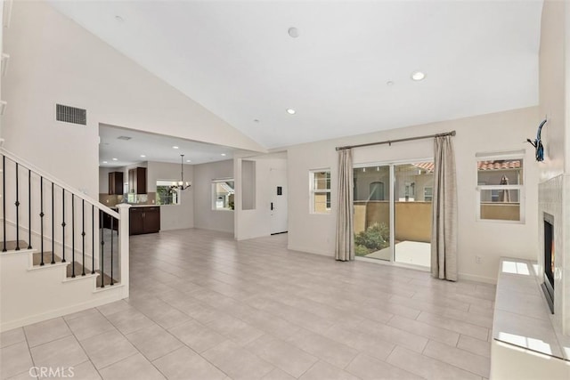 38472 Glen Abbey Ln, Murrieta, CA 92562 - unfurnished living room featuring stairway, a tile fireplace, a chandelier, high vaulted ceiling, and recessed lighting