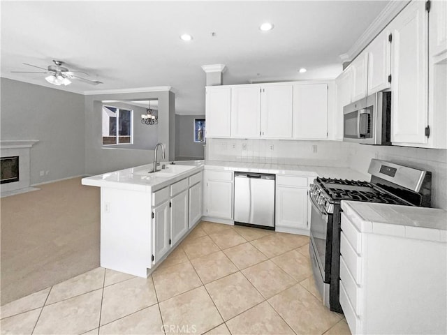 7411 Bull Run Pl, Fontana, CA 92336 - kitchen featuring appliances with stainless steel finishes, a peninsula, a sink, tile countertops, and a chandelier