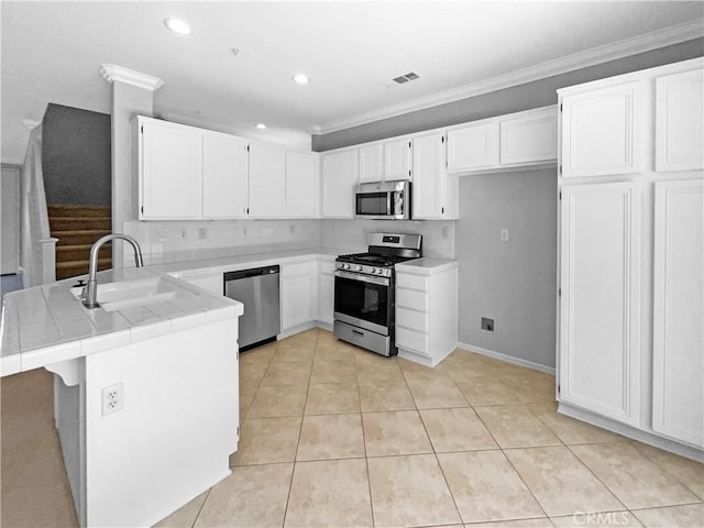 7411 Bull Run Pl, Fontana, CA 92336 - kitchen with appliances with stainless steel finishes, a sink, a peninsula, tile counters, and crown molding