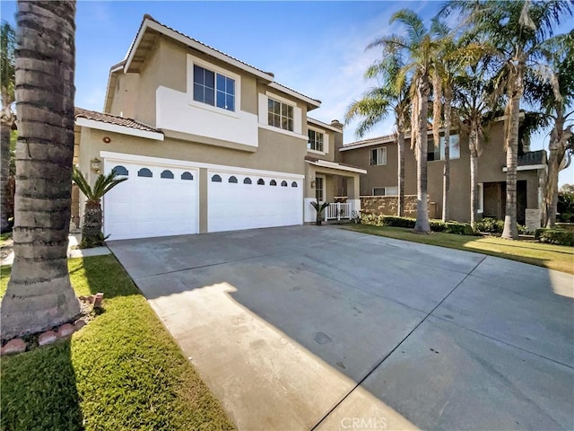 7411 Bull Run Pl, Fontana, CA 92336 - view of front of property with stucco siding, driveway, and an attached garage