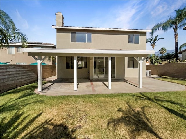 7411 Bull Run Pl, Fontana, CA 92336 - back of house featuring stucco siding, a chimney, and a patio