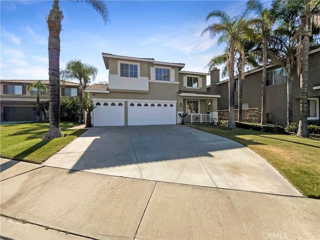 7411 Bull Run Pl, Fontana, CA 92336 - view of front facade featuring stucco siding, a garage, driveway, and a front yard