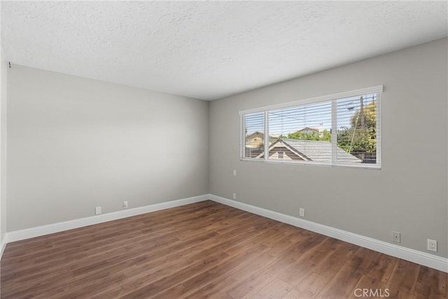 4198 Woodland St, Santa Maria, CA 93455 - spare room featuring wood finished floors, baseboards, and a textured ceiling
