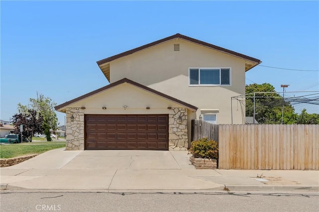 4198 Woodland St, Santa Maria, CA 93455 - view of front of house with stone siding, stucco siding, concrete driveway, and a garage