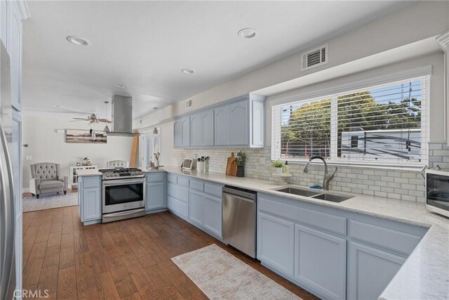 4198 Woodland St, Santa Maria, CA 93455 - kitchen with stainless steel appliances, a sink, island exhaust hood, light countertops, and backsplash