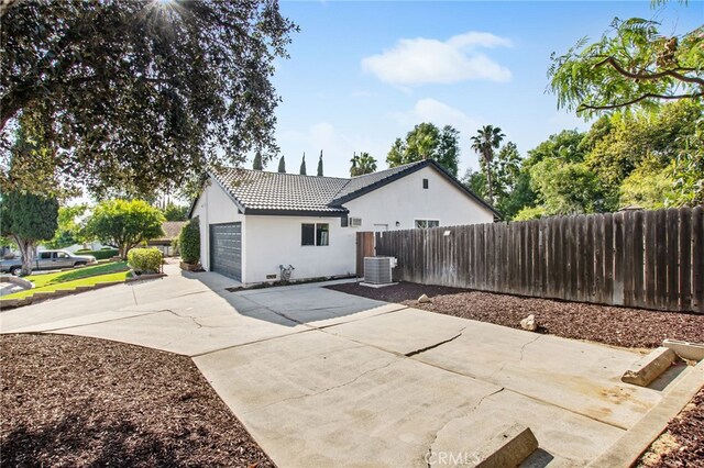 18165 Sharon Cir, Yorba Linda, CA 92886 - rear view of property featuring stucco siding, a tile roof, driveway, and a garage