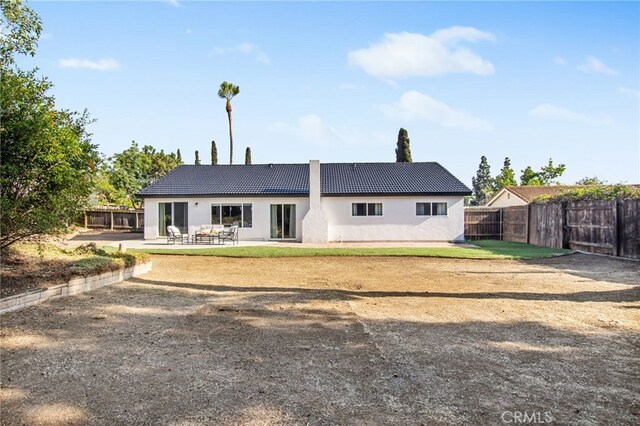 18165 Sharon Cir, Yorba Linda, CA 92886 - back of house with a tile roof, stucco siding, and a patio area