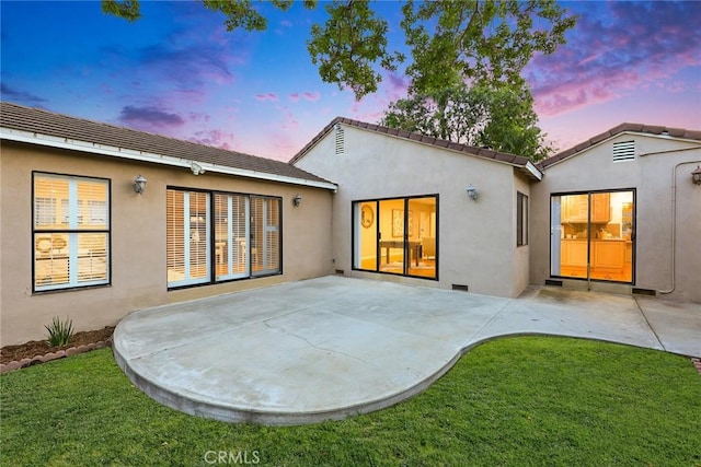 314 S Old Ranch Rd, Arcadia, CA 91007 - back of property at dusk featuring stucco siding, a patio, and a yard