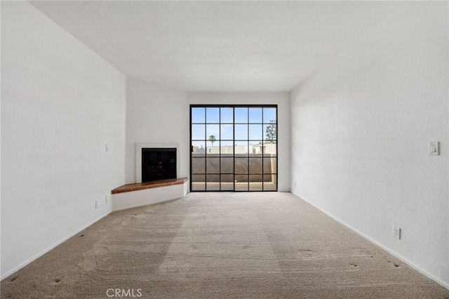 221 S Oak Knoll Ave Unit 308, Pasadena, CA 91101 - unfurnished living room with carpet flooring, a fireplace with raised hearth, and baseboards