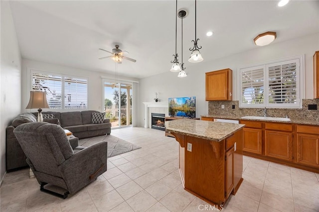 39798 Fairview Ct, Murrieta, CA 92563 - kitchen with open floor plan, a sink, brown cabinetry, and a kitchen island