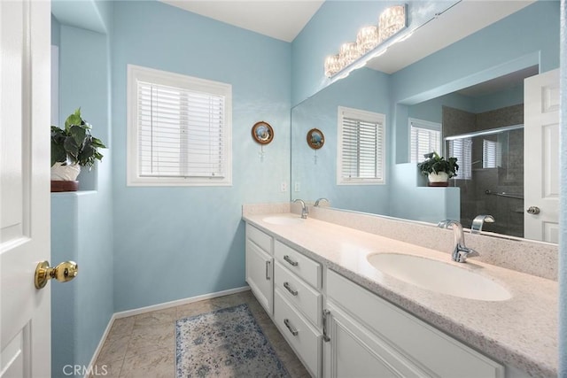 39798 Fairview Ct, Murrieta, CA 92563 - bathroom featuring double vanity, tiled shower, and baseboards