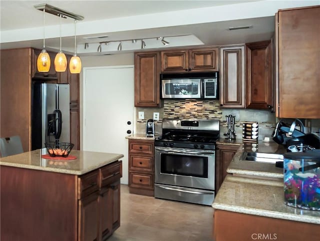 11103 Muirfield Dr, Rancho Cucamonga, CA 91730 - kitchen featuring stainless steel appliances, decorative backsplash, hanging light fixtures, and light stone counters
