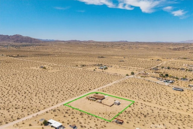 63357 Uranium Rd, Joshua Tree, CA 92252 - aerial view of sparsely populated area with property boundaries highlighted, a desert landscape, and mountains