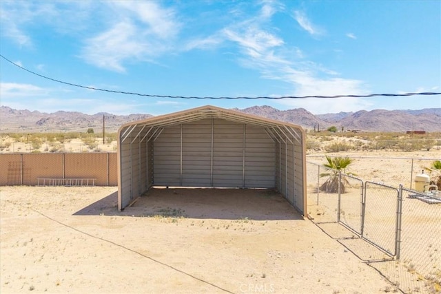 63357 Uranium Rd, Joshua Tree, CA 92252 - garage with a mountain view, a carport, and a gate