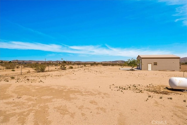 63357 Uranium Rd, Joshua Tree, CA 92252 - view of yard with a desert view, a mountain view, an outbuilding, and a view of rural / pastoral area