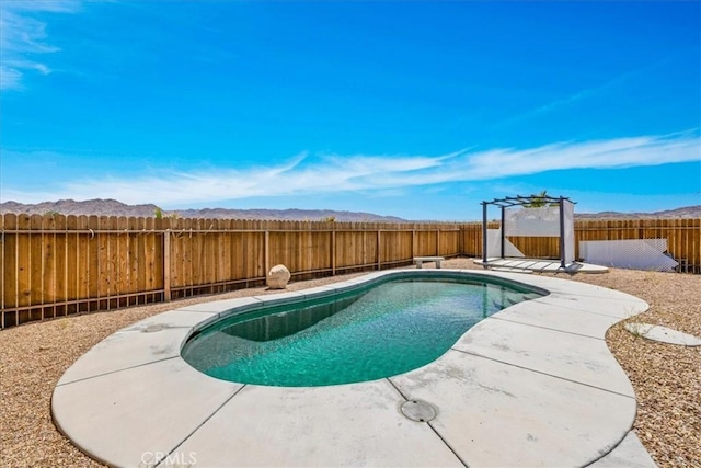 63357 Uranium Rd, Joshua Tree, CA 92252 - view of swimming pool with a fenced backyard, a mountain view, and a patio area