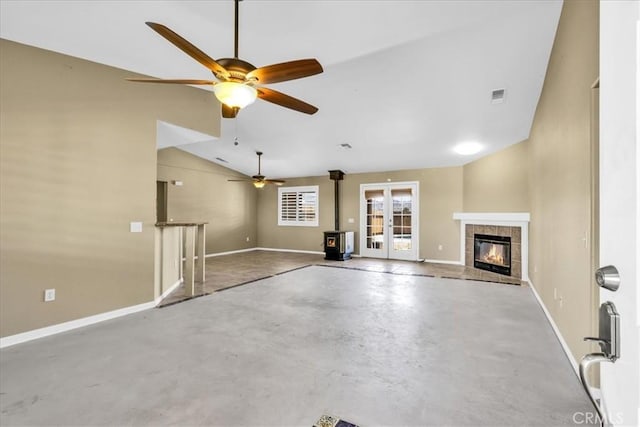 63357 Uranium Rd, Joshua Tree, CA 92252 - unfurnished living room featuring concrete flooring, baseboards, lofted ceiling, ceiling fan, and a tiled fireplace